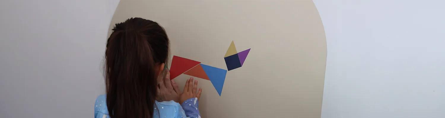 Little girl creating fun shapes with her tangram (Blog)